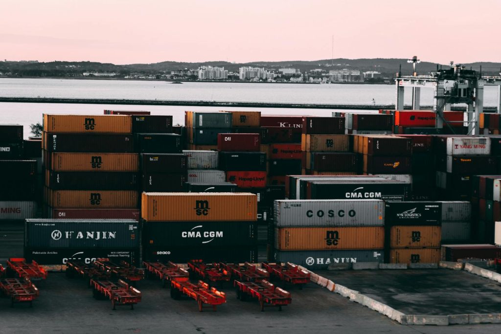Assorted-color Cargo Containers Near Body of Water